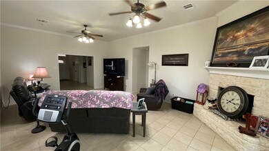 Living room with ceiling fan, tile patterned floor