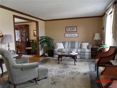 Formal livingroom with hardwood flooring and crown