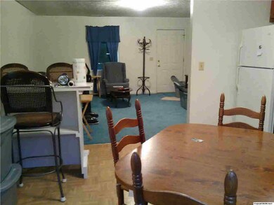 Owner in the process of packing. This is a view from the back door in the kitchen to the livingroom.