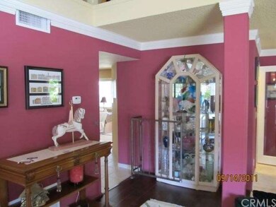 Entry hallway. Notice the custom paint and wood flooring