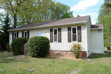 View of home showing exterior attached storage room on right.