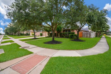 Over sized corner lot with mature trees, plush grass and lush landscape.