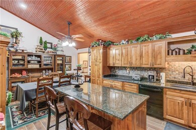 Kitchen featuring black dishwasher, tasteful backs