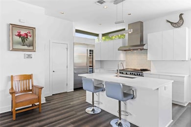 Kitchen featuring light countertops, a sink, high