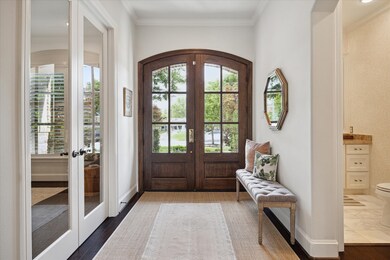 Entry with engineered wood floors, crown molding a
