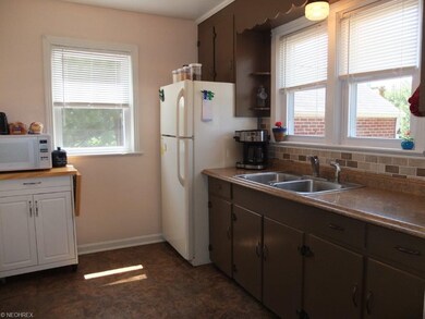 Kitchen with updated tile backsplash and counterto
