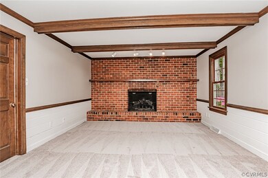 Family Room with NEW carpet, brick fireplace with