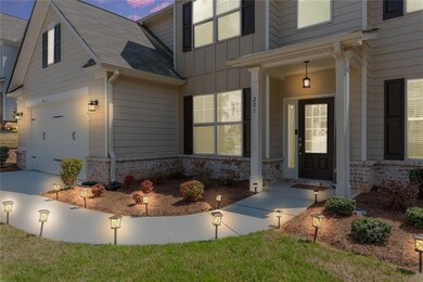 Doorway to property featuring a porch, board and batten siding, and a garage