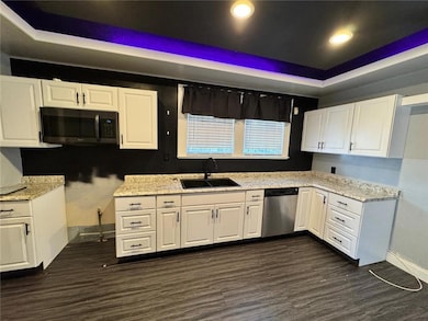 Kitchen with dark hardwood / wood-style flooring, 
