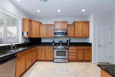 Kitchen with sink, light tile patterned flooring,