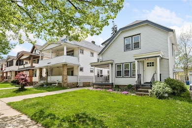 View of front of property with a front lawn and a balcony