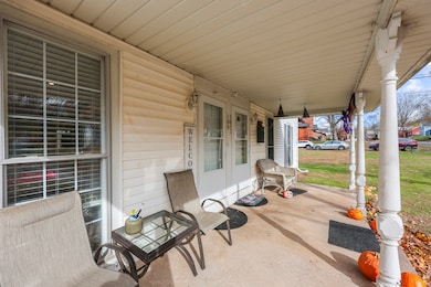 Covered front porch that offers dual welcomings out from the elements.