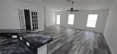 Living area featuring wood finished floors, basebo