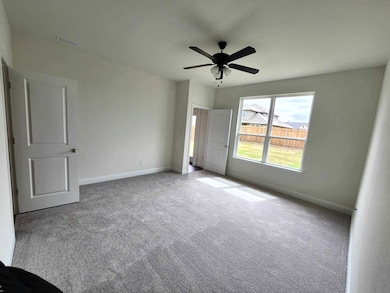 Unfurnished room featuring ceiling fan and light carpet