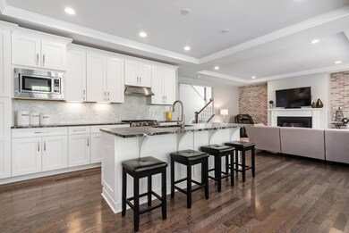 Fabulous upgraded Kitchen with maple Shaker style cabinetry with soft close and roll out drawers. There is wiring above the island for pendant lights if desired. The backsplash is the perfect contrast to the dark leather granite countertops.