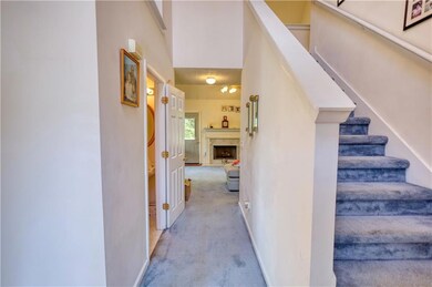 Stairs with carpet floors and a high end fireplace
