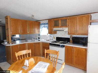 The kitchen is clean and the appliances are all in