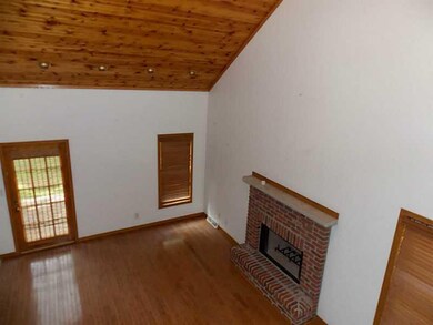 2 story living room with hardwood floors, fireplac