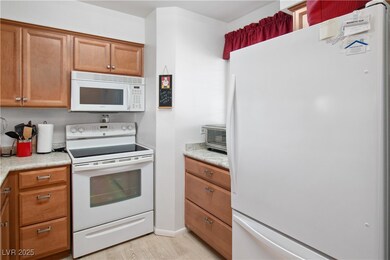 The Kitchen has a white fridge / freezer, microwav
