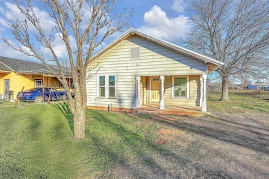 Bungalow with a front lawn and covered porch
