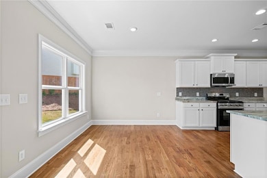Kitchen featuring baseboards, ornamental molding, 