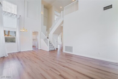 Unfurnished living room featuring stairs, wood fin