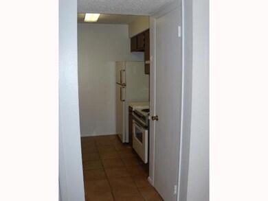 Kitchen with light countertops, light tile patter