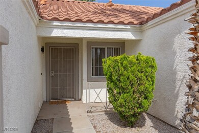 Property entrance featuring stucco siding and a ti