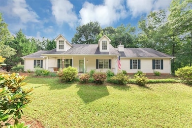 New england style home featuring a front lawn and a porch