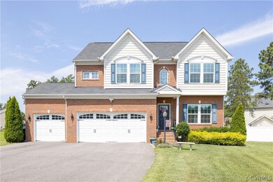 The brick-front and three car garage hint at the b