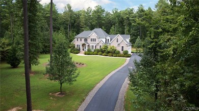Paved driveway is skillfully accented with stone edges.