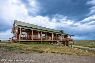 View of front facade with covered porch and a meta