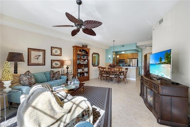 Tiled living room featuring ceiling fan