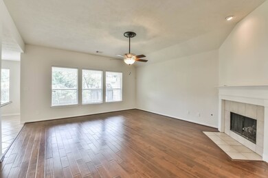 Living room with wall of windows, hardwood floors and gas fireplace