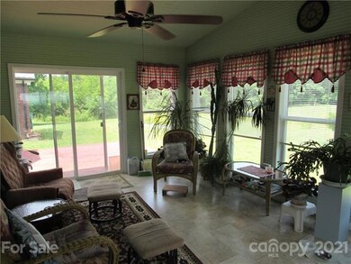 The sunroom has a panoramic view of the backyard