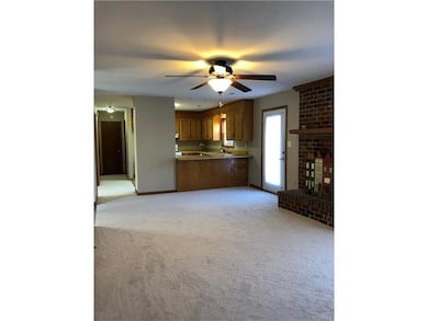 Family room looking into kitchen and hallway towar