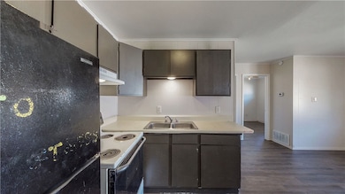 Kitchen featuring freestanding refrigerator, under