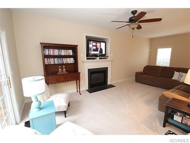 Living room with carpet, gas fireplace, built in- 