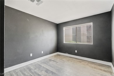 Spare room with wood finished floors and baseboard