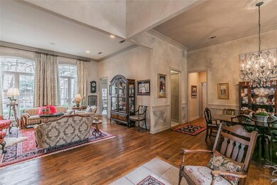 Hand-scraped wood floors welcome you into the formal living room and dining room