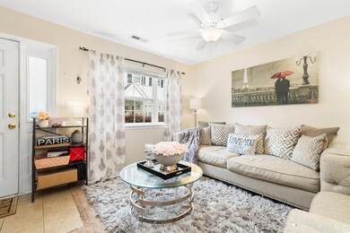 Tiled living room featuring ceiling fan