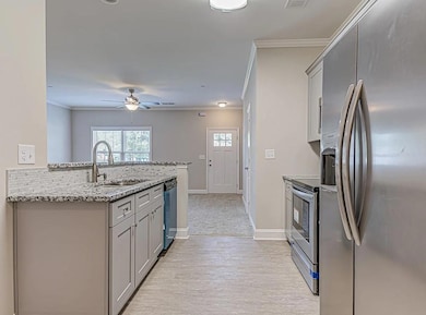 Kitchen featuring kitchen peninsula, stainless ste