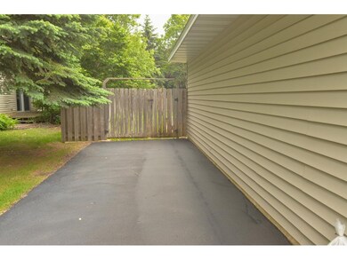 The extension of the asphalt driveway leads all th