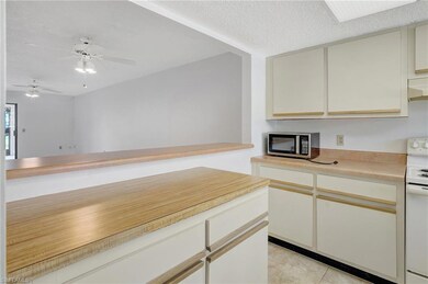 Kitchen featuring white electric range oven, a tex