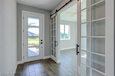 Doorway with a barn door, french doors, a wealth o