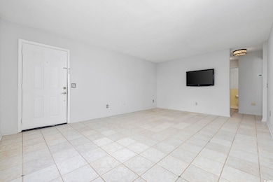 Unfurnished living room with light tile floors