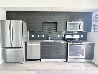 Kitchen featuring stainless steel appliances, lig