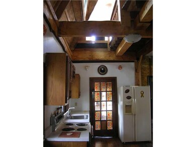 Kitchen. Cathedral type ceiling is open to loft ab