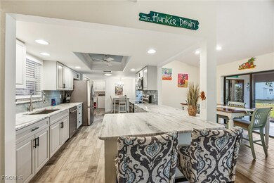 Kitchen with tasteful backsplash, light wood-style tile floors, leather finish granite countertops, and recessed lighting