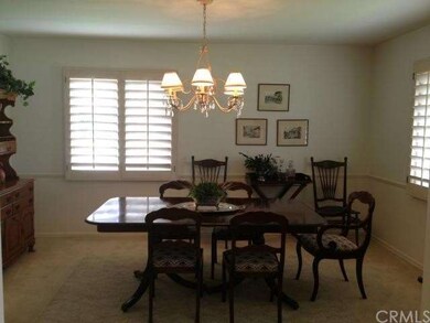 Formal dining room with plantation shutters.